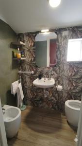 a bathroom with a sink and a toilet and a mirror at Penthouse a Silvi Marina in San Silvestro +17 photos