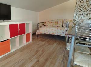 a small room with a bed and a couch at Penthouse a Silvi Marina in San Silvestro