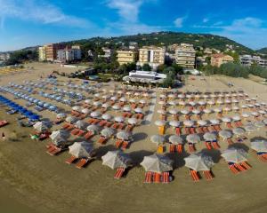 a large group of umbrellas and chairs on a beach at Penthouse a Silvi Marina in San Silvestro