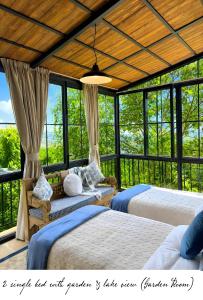 two beds in a room with windows at Laklouk 1808 Lodge by Hansa in ‘Ayn aş Şalīb +39 photos