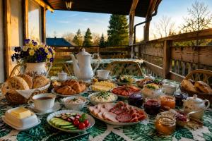 a table topped with plates of food on a table at Danielówka in Ciemiętniki