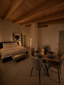 a bedroom with a bed and a table and chairs at PaderCityLoft Apartment Pfau in Paderborn