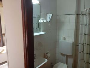 a bathroom with a shower and a toilet and a sink at samos town hostel in Samos
