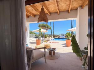 a living room with a patio with a view of a pool at Can Paola in Sant Josep