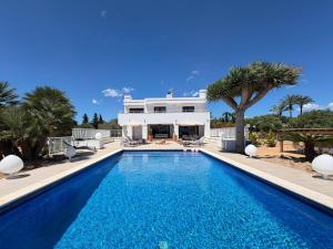 a swimming pool in front of a villa at Can Paola in Sant Josep