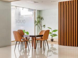 a table and four chairs in a room at Guide Hotel Taipei Bade in Taipei