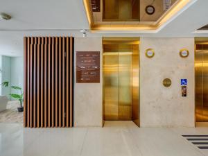 a lobby with a elevator in a building at Guide Hotel Taipei Bade in Taipei
