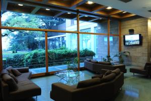 a lobby with couches and a television in a building at Villa Cagnola in Varese