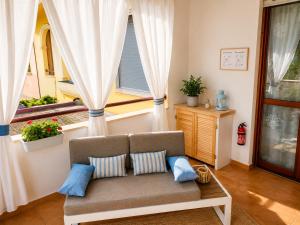 a living room with a couch and a window at Quiet Home in Pula +25 photos