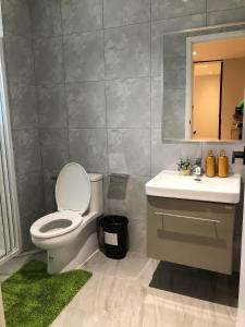 a bathroom with a toilet and a sink and a mirror at BaanTip​ HomeStay in Amphoe Phra Khanong +16 photos