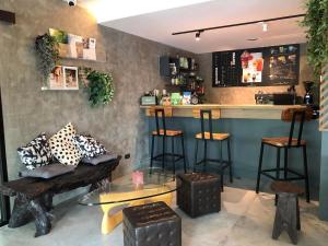 a bar with stools and a counter in a restaurant at BaanTip​ HomeStay in Amphoe Phra Khanong