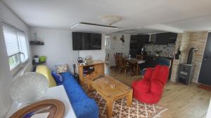 a living room with red chairs and a blue couch at La Hasienda in Geldern +27 photos