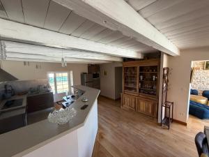 a kitchen and living room with wooden floors and ceilings at gîte du bel étang in Commenailles