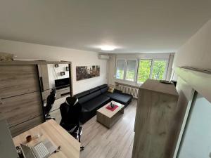 a living room with a couch and a table at Comfy Flat in New Belgrade in Belgrade