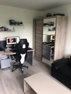 an office with a desk with a chair and a computer at Comfy Flat in New Belgrade in Belgrade