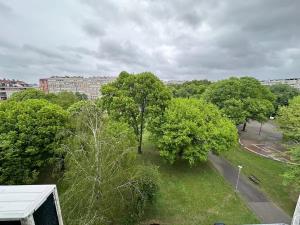 a view of a park with trees and a street at Comfy Flat in New Belgrade in Belgrade