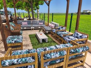a patio with several couches and a table and a table at Mas Panoli in Deltebre