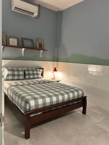 a bedroom with a bed with a checkered blanket at Island House Rentals 40 in Ko Samed