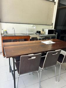 a kitchen with a large wooden table with chairs at Island House Rentals 40 in Ko Samed