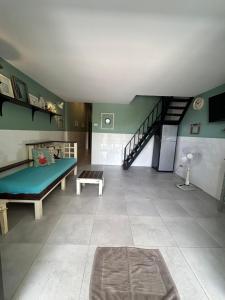 a living room with a bed and a staircase at Island House Rentals 40 in Ko Samed