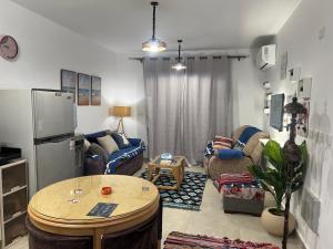 a living room with a couch and a table at Mountain View Chalet in Ras El Hekma ماونتن ڤيو رأس الحكمة in Ras Elhekma