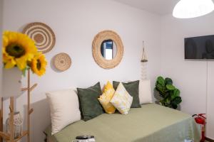 a room with a couch with pillows and a mirror at Agnanti Seaview Villa in Karlovasi