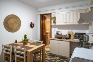 a kitchen with a wooden table and a counter top at Agnanti Seaview Villa in Karlovasi