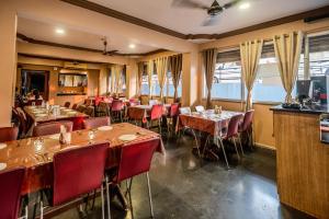 a restaurant with tables and chairs in a room at Laxman Avenue in Jagdalpur