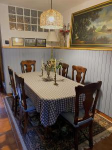 a dining room with a table with chairs and a painting at Legendarium Casa Rural in Salamón