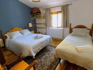 a bedroom with two beds and a window at Legendarium Casa Rural in Salamón +43 photos