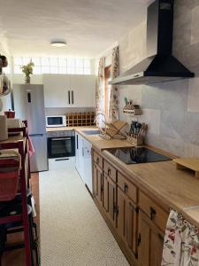 a kitchen with a sink and a stove top oven at Legendarium Casa Rural in Salamón