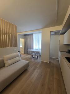 a living room with a couch and a table at EMERALD Suites Cervia in Cervia