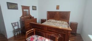 a bedroom with a wooden bed and wooden furniture at Suite IN PIAZZA in Poggio Renatico