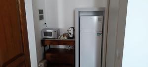 a kitchen with a white refrigerator and a microwave at Suite IN PIAZZA in Poggio Renatico