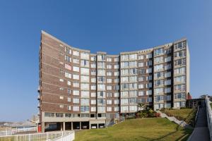 a large brick building with many windows on it at Peacehaven 108 in Scottburgh