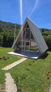a small house with a pitched roof on a field at Bella Home in Rap