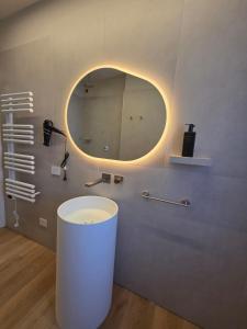 a bathroom with a white sink and a mirror at EMERALD Suites Cervia in Cervia +34 photos