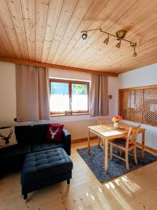 a living room with a couch and a table at Ferienwohnung Schösserhof in Reith bei Kitzbühel