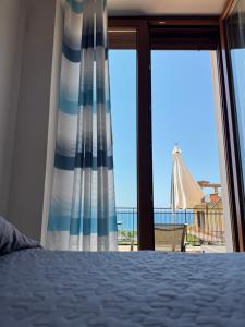 a bedroom with a bed and a view of the ocean at Supramonte Guesthouse in Agropoli