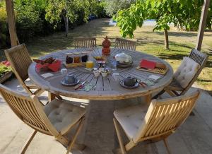 a wooden table with food on top of it at La Maison d'eglantine in Marnaves