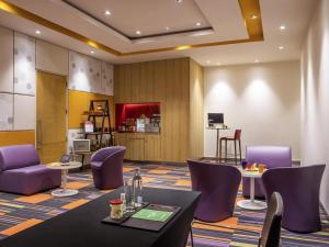 a conference room with tables and purple chairs at Ibis Chennai OMR - An Accor Brand in Chennai