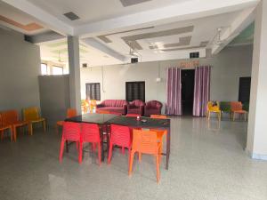 a conference room with a table and chairs at Vivek Hotel in Banbāsa