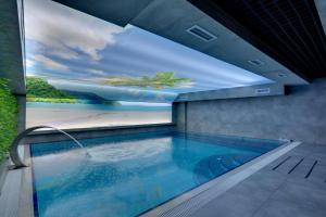 a swimming pool with a painting on the wall at Grande Arte Hotel in Eskisehir