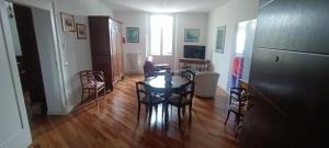 a living room with a table and chairs at Suite IN PIAZZA in Poggio Renatico