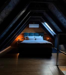 a bedroom with a bed in the attic at Zoe Luxury House in Gomirje +35 photos