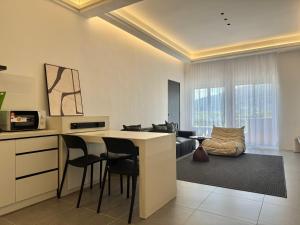a kitchen and living room with a table and chairs at Langkawi Simfoni Beliza Apartment with Sky Pool by Zervin in Kuah