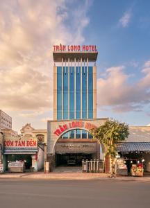 a building with a tower with a train long hotel at Tran Long Hotel By Urban B in Ho Chi Minh City