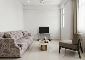 a living room with a couch and a chair at MSM DIAMOND guesthouse 1 in Male City
