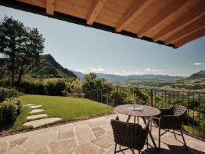 a patio with a table and chairs and a view at Anima-Suites adults only in Terlano
