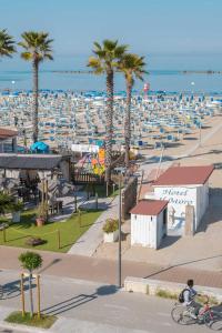 a person riding a bike in front of a beach at Hotel IL MORO in Roseto degli Abruzzi
